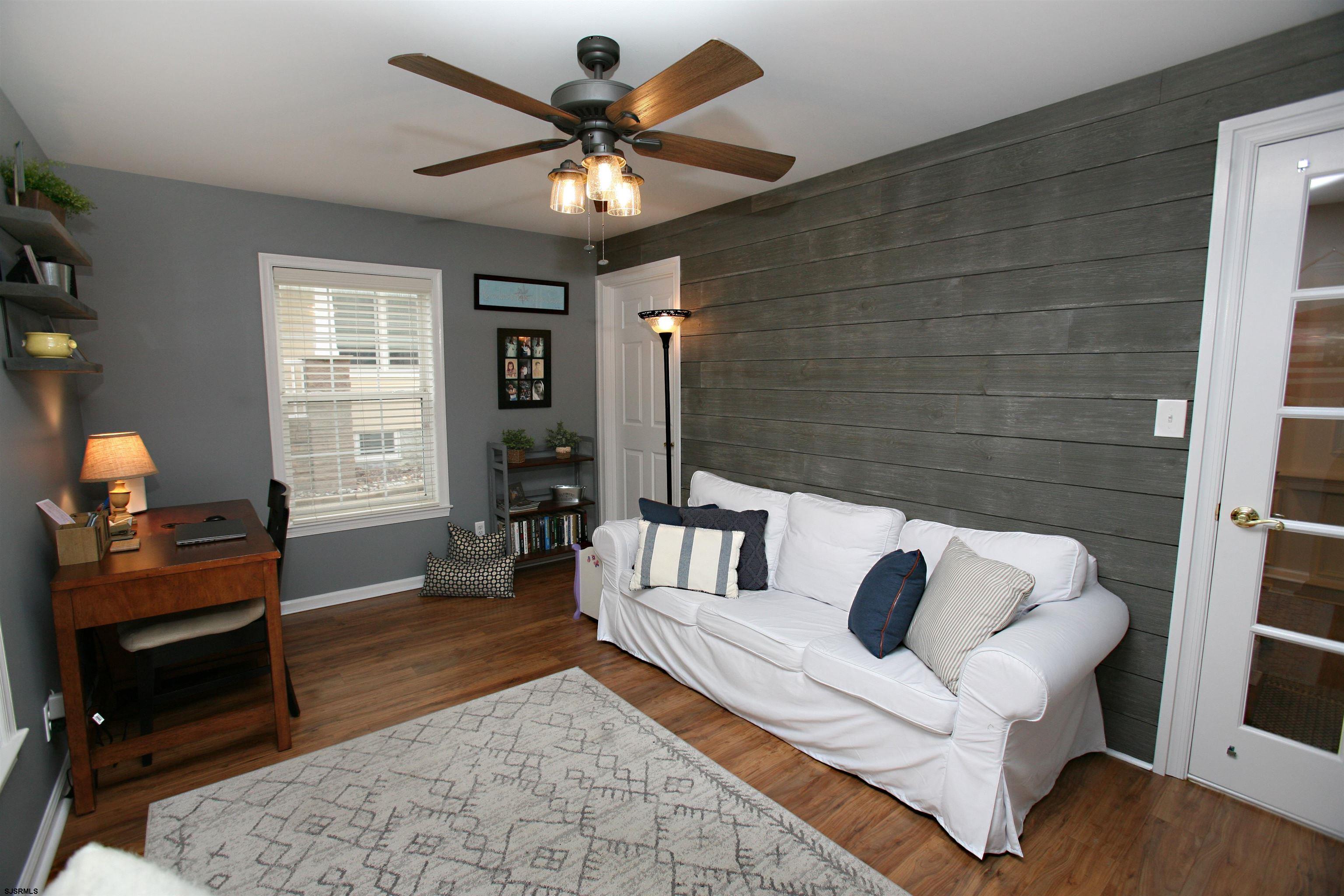 556 Grape Street Hammonton, NJ 08037 - Photo 3 of 26 a bedroom with furniture and a chandelier