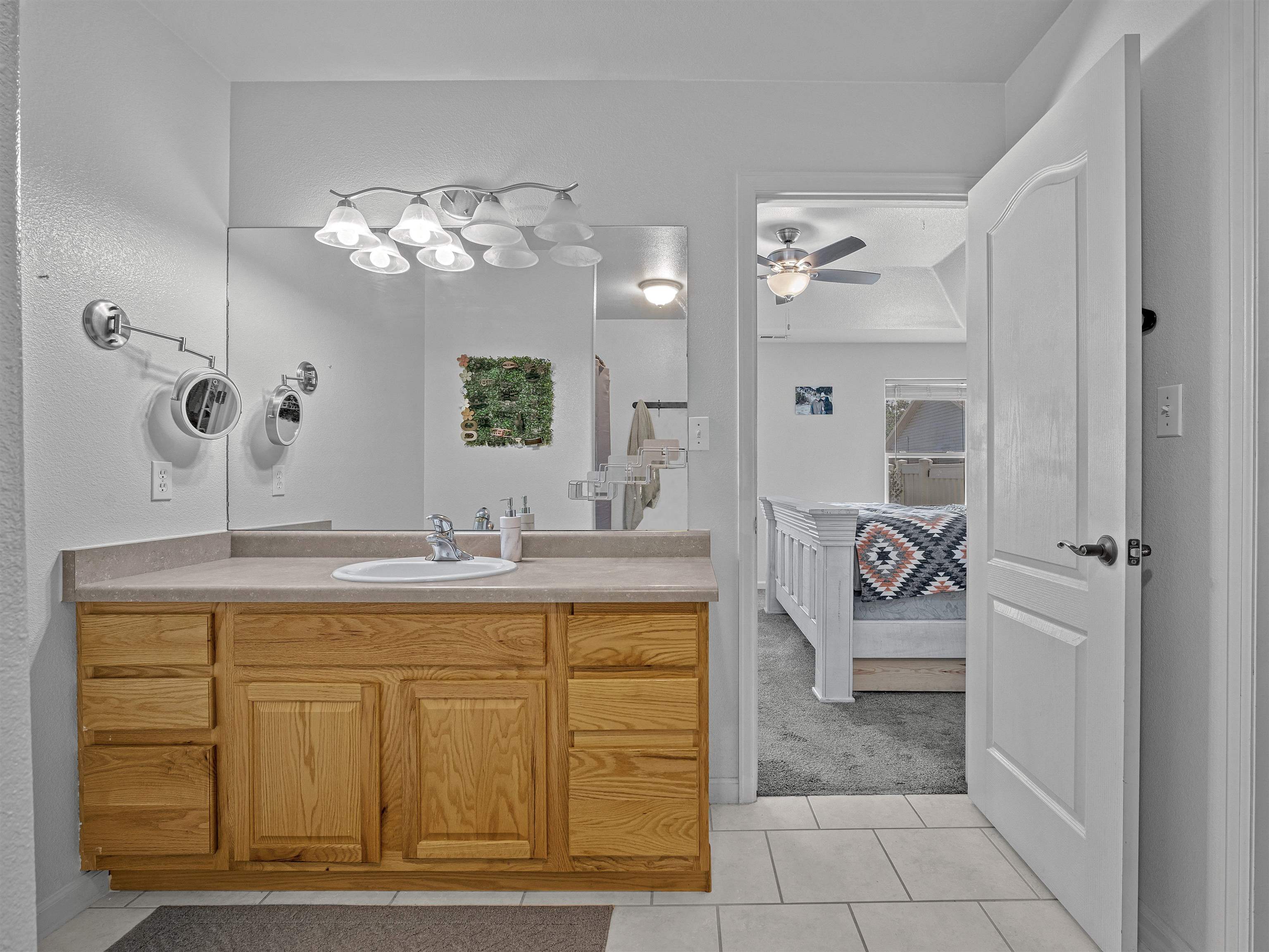 680 Stone Mountain Drive Fruita, CO 81521 - Photo 13 of 32 a spacious bathroom with a granite countertop sink a mirror and a