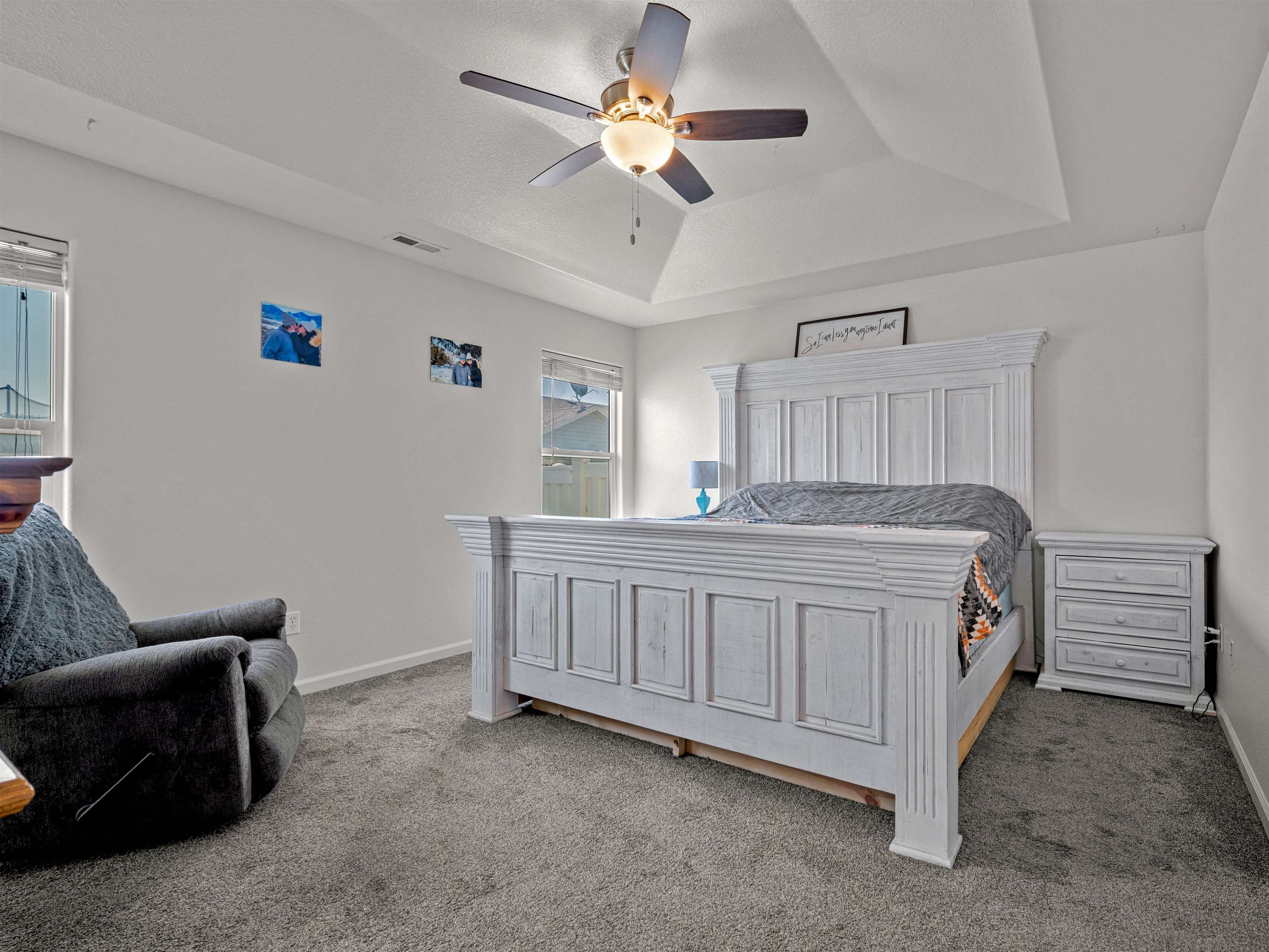 680 Stone Mountain Drive Fruita, CO 81521 - Photo 19 of 32 a bedroom with a bed and a chandelier