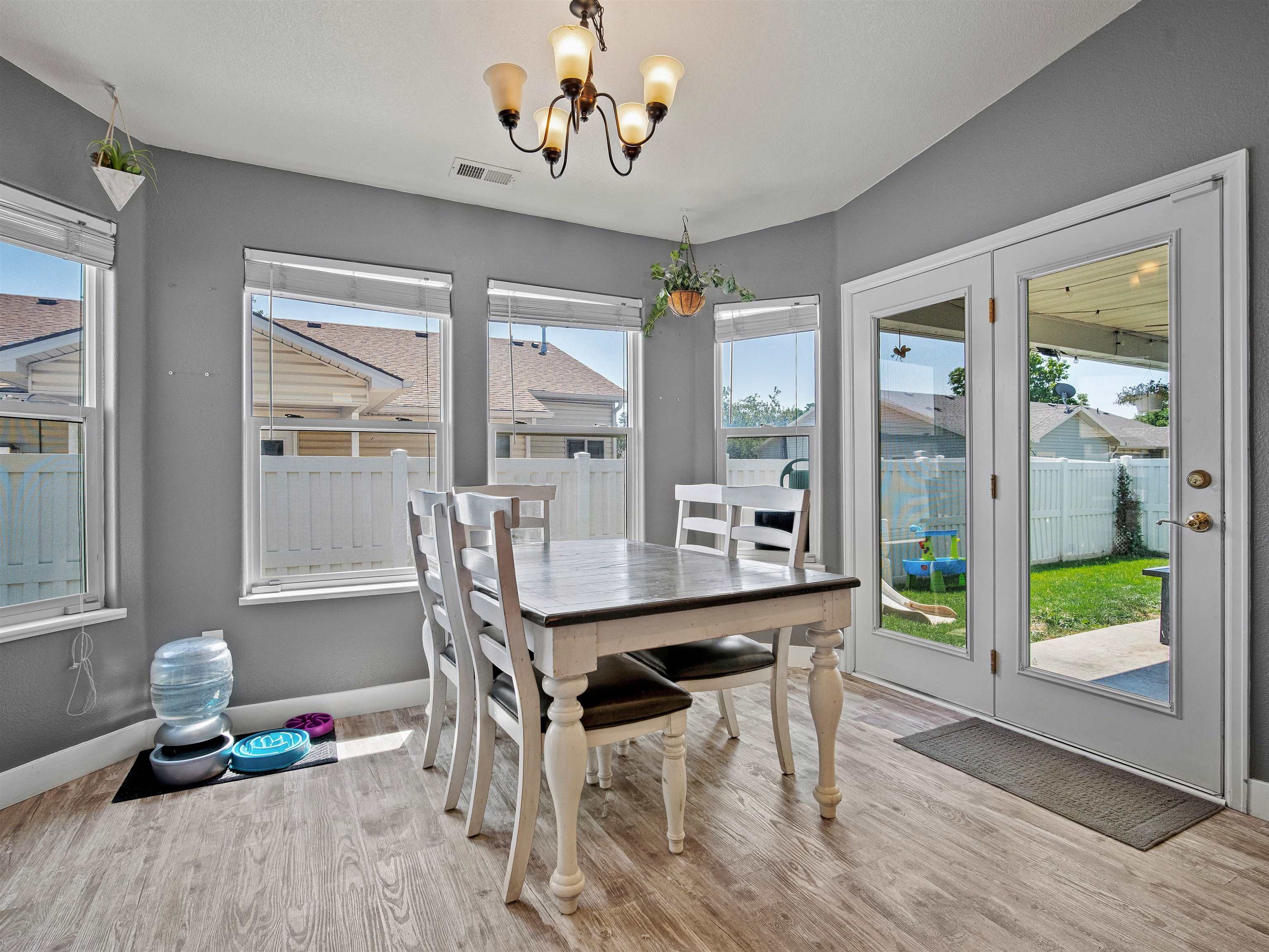 680 Stone Mountain Drive Fruita, CO 81521 - Photo 20 of 32 a dining room with wooden floor and a chandelier