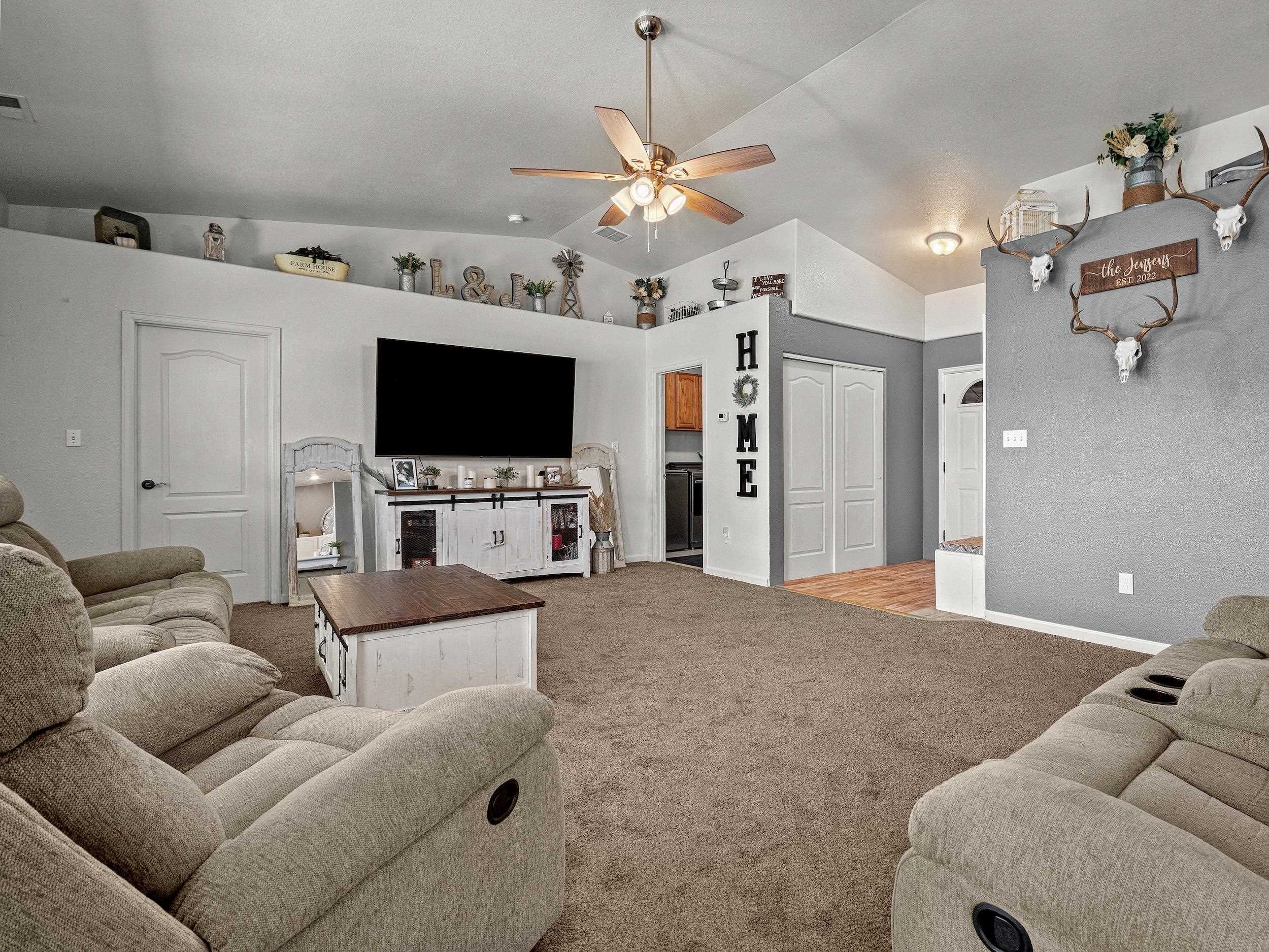 680 Stone Mountain Drive Fruita, CO 81521 - Photo 2 of 32 a living room with furniture and a flat screen tv