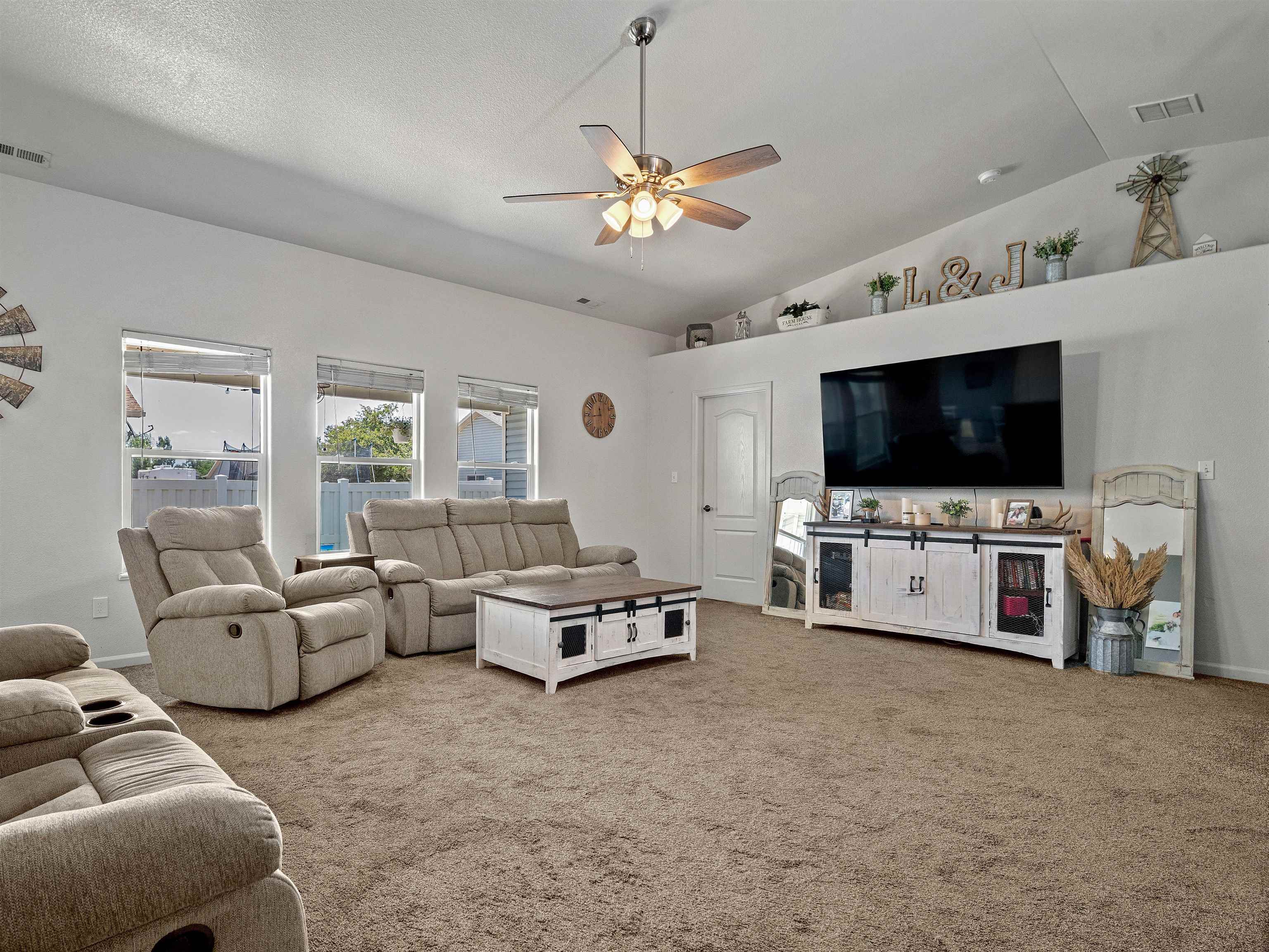680 Stone Mountain Drive Fruita, CO 81521 - Photo 24 of 32 a living room with furniture and a flat screen tv