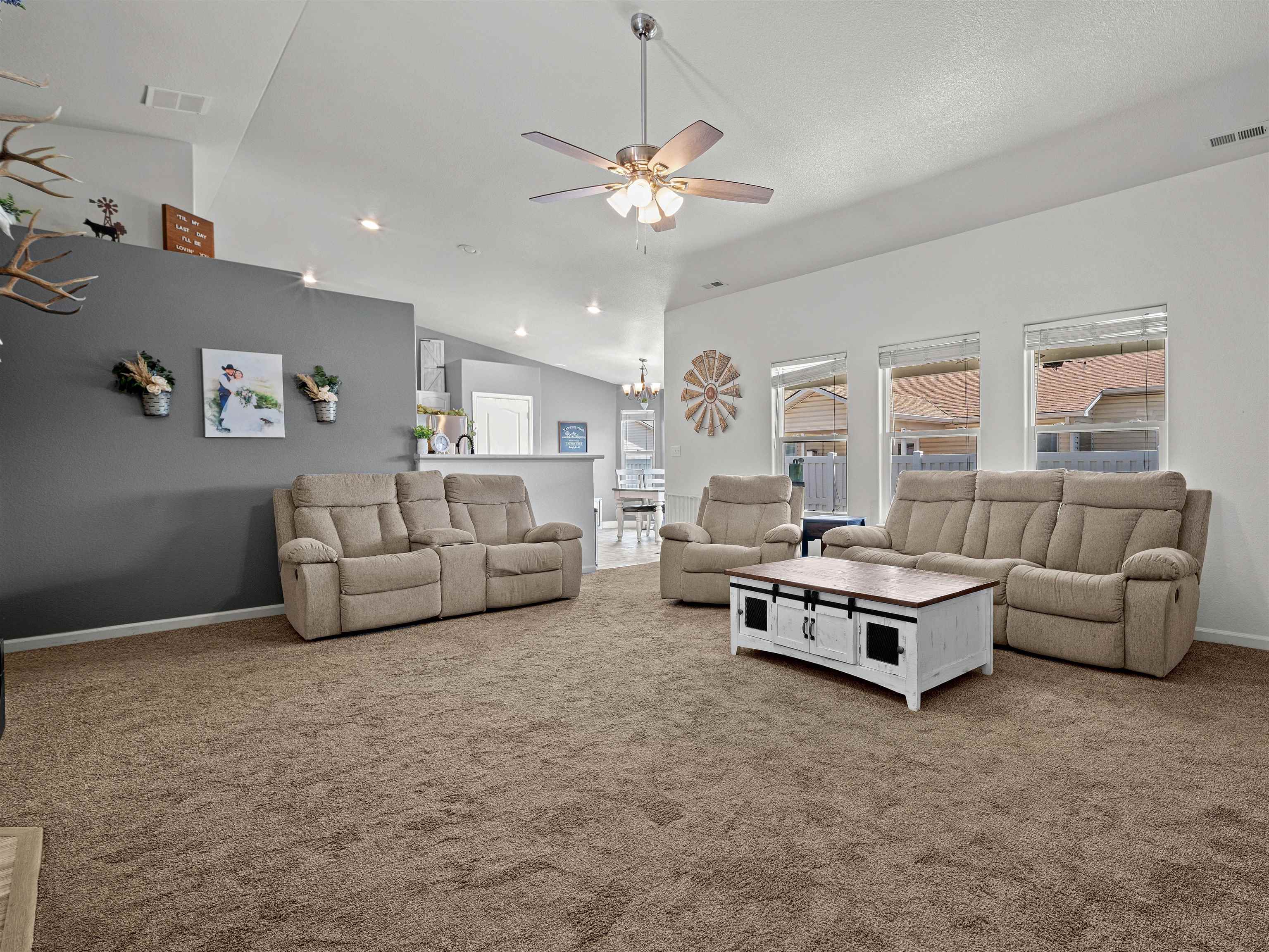680 Stone Mountain Drive Fruita, CO 81521 - Photo 25 of 32 a living room with furniture and a chandelier