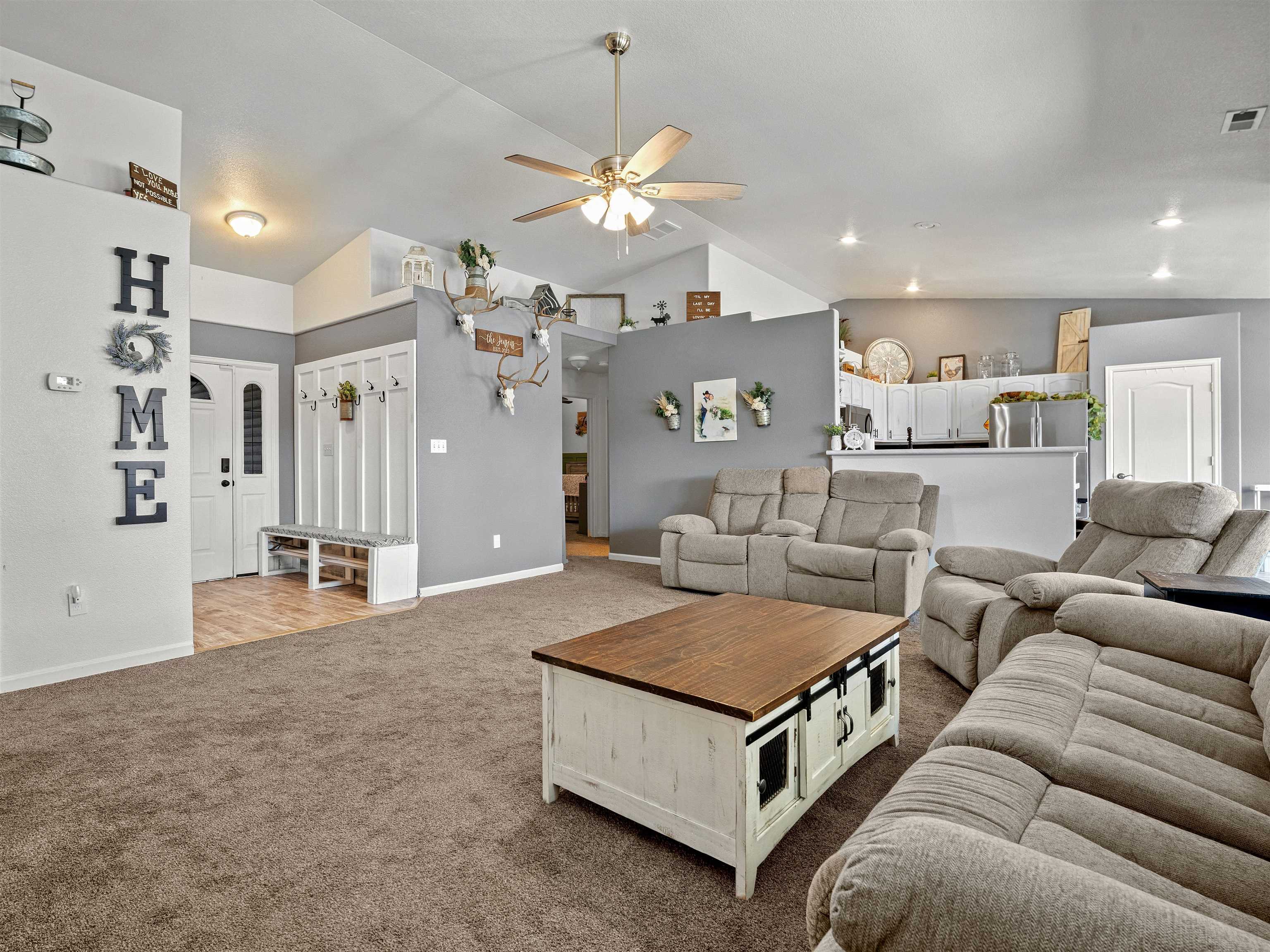 680 Stone Mountain Drive Fruita, CO 81521 - Photo 27 of 32 a living room with furniture and a chandelier