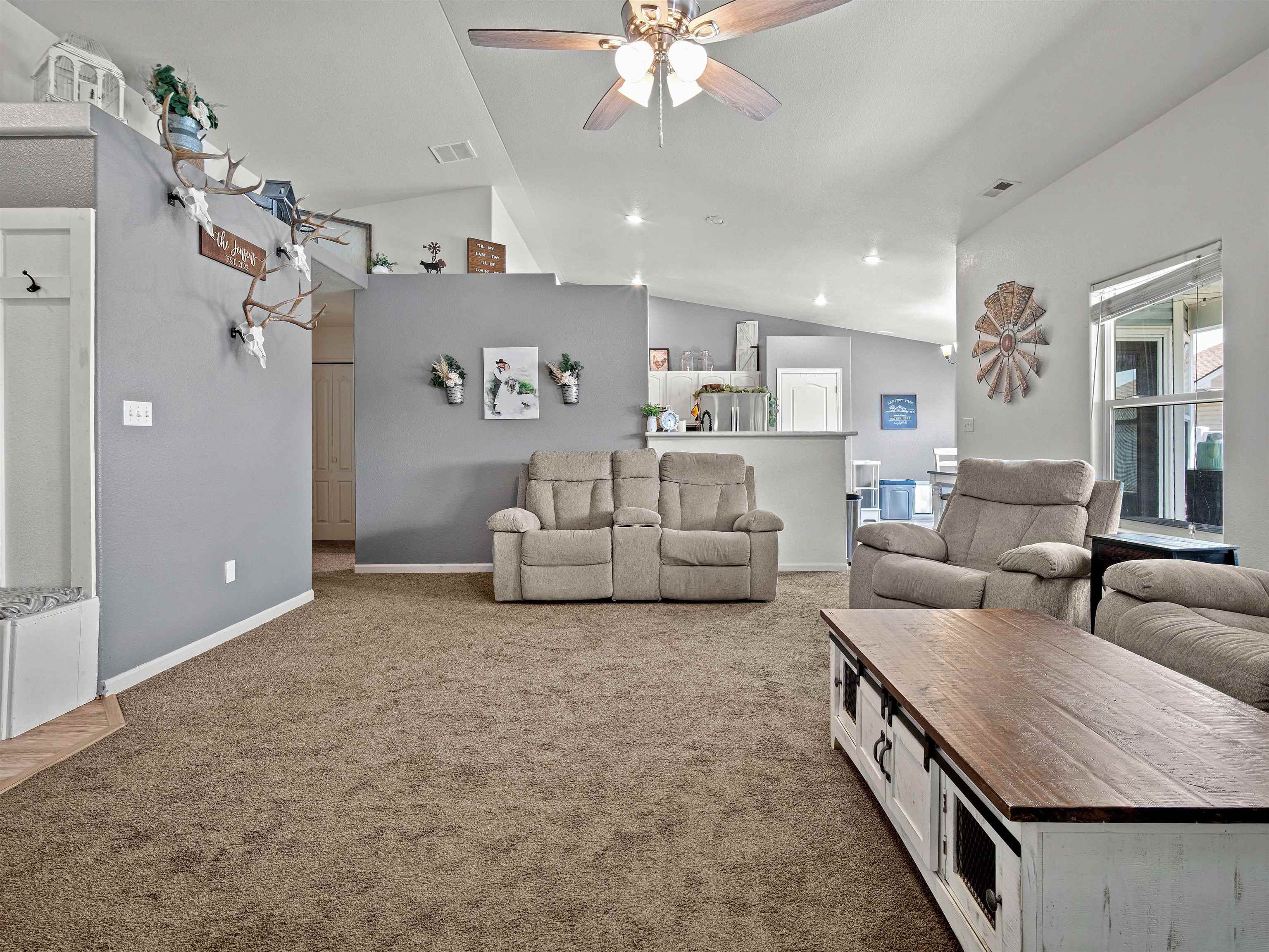 680 Stone Mountain Drive Fruita, CO 81521 - Photo 28 of 32 a living room with furniture and a chandelier