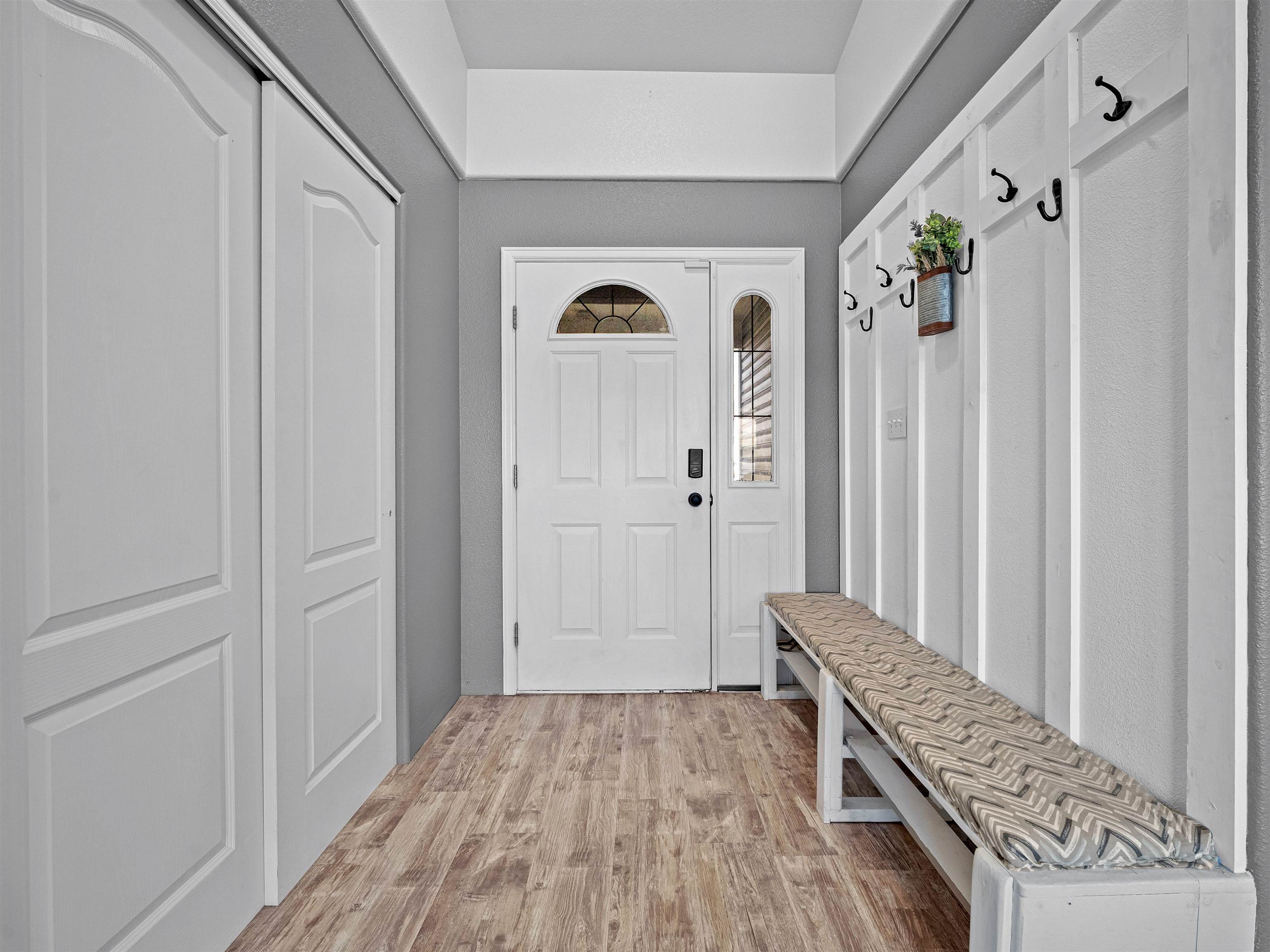 680 Stone Mountain Drive Fruita, CO 81521 - Photo 29 of 32 a view of a hallway with wooden floor and staircase