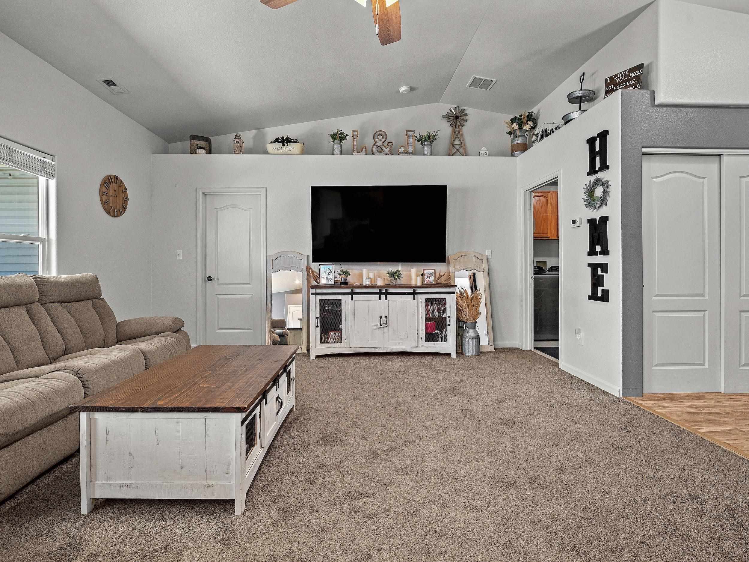 680 Stone Mountain Drive Fruita, CO 81521 - Photo 3 of 32 a living room with furniture and a flat screen tv