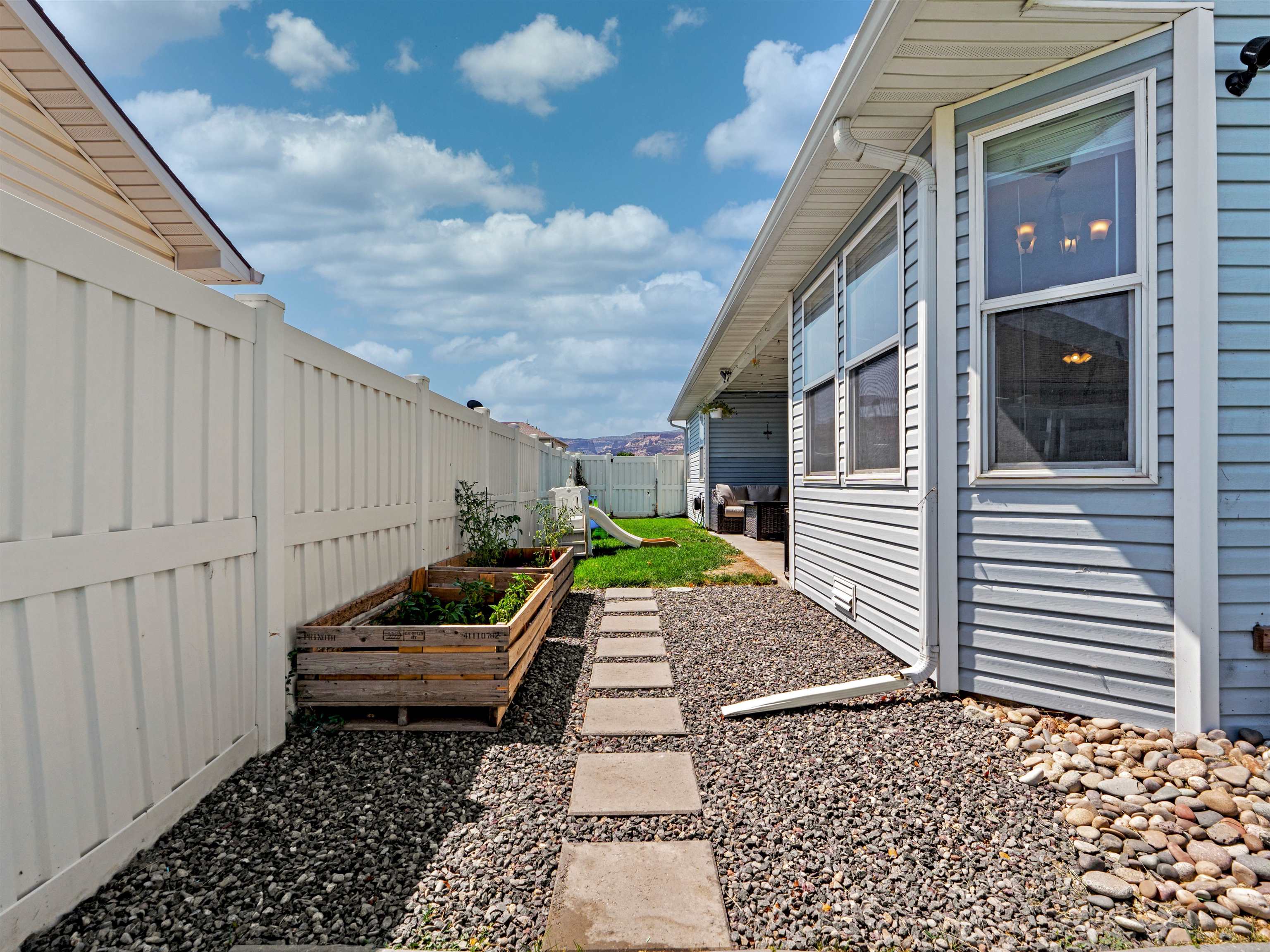 680 Stone Mountain Drive Fruita, CO 81521 - Photo 4 of 32 a backyard of a house with a garden