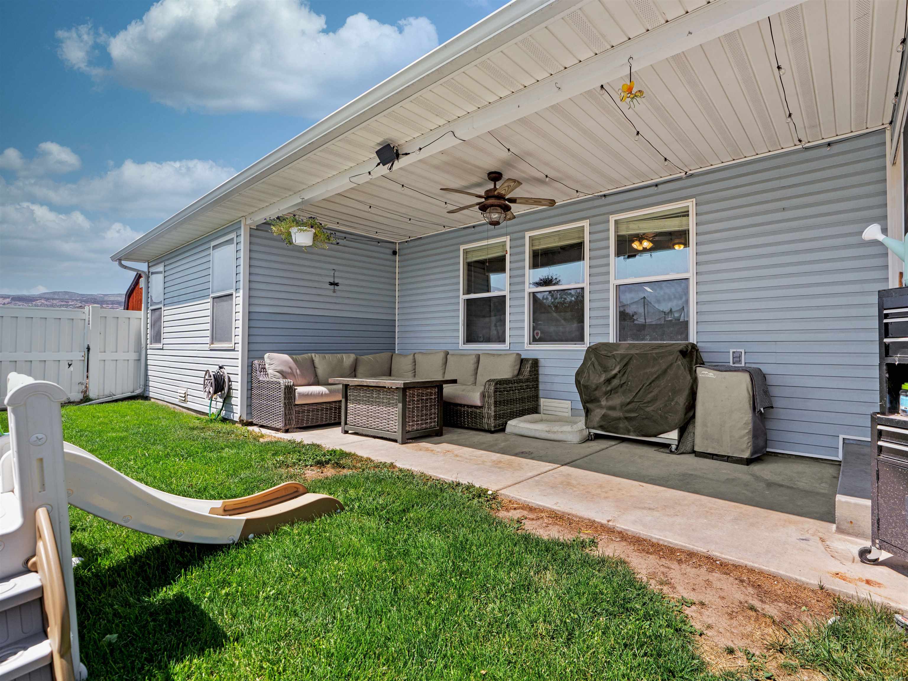 680 Stone Mountain Drive Fruita, CO 81521 - Photo 10 of 32 a view of a patio with chairs and a backyard