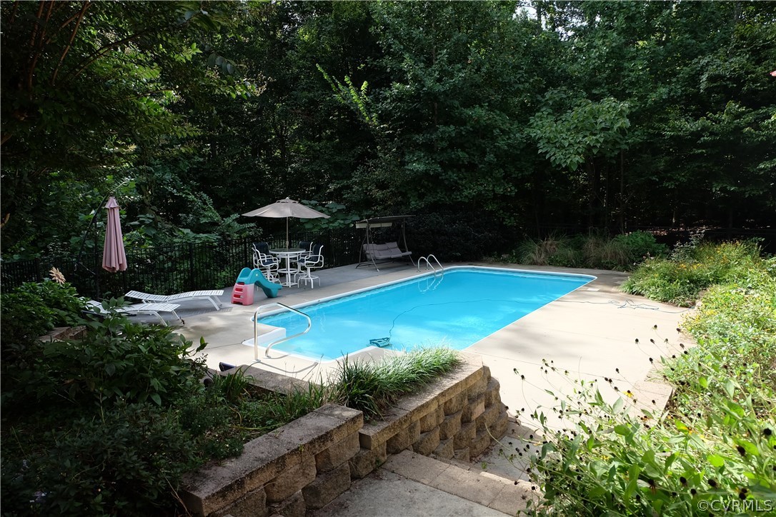 11903 Reeds Bluff Lane Midlothian, VA 23113 - Photo 23 of 24 a view of a swimming pool with a patio
