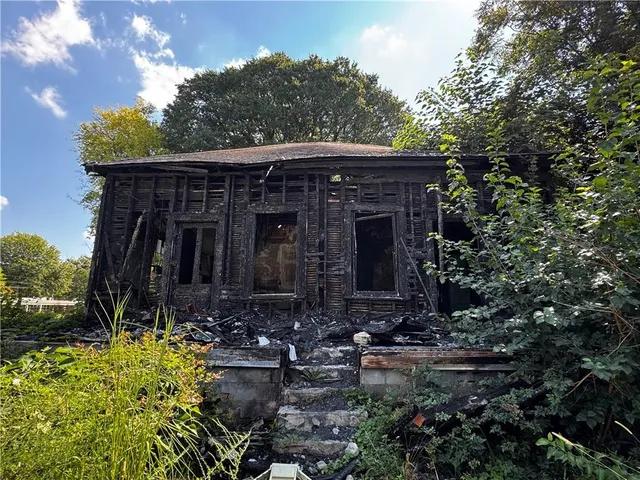 a view of house with yard and green space