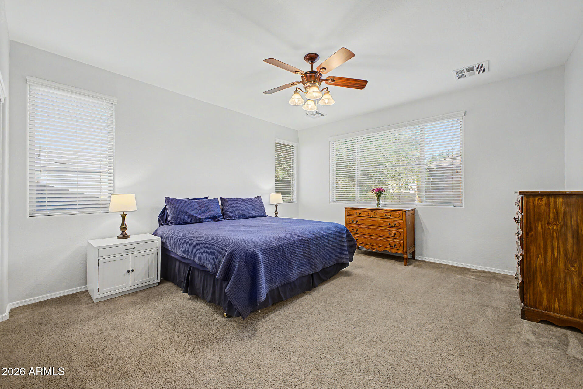 4331 East Cullumber Street Gilbert, AZ 85234 - Photo 16 of 42 a spacious bedroom with a bed and a chandelier