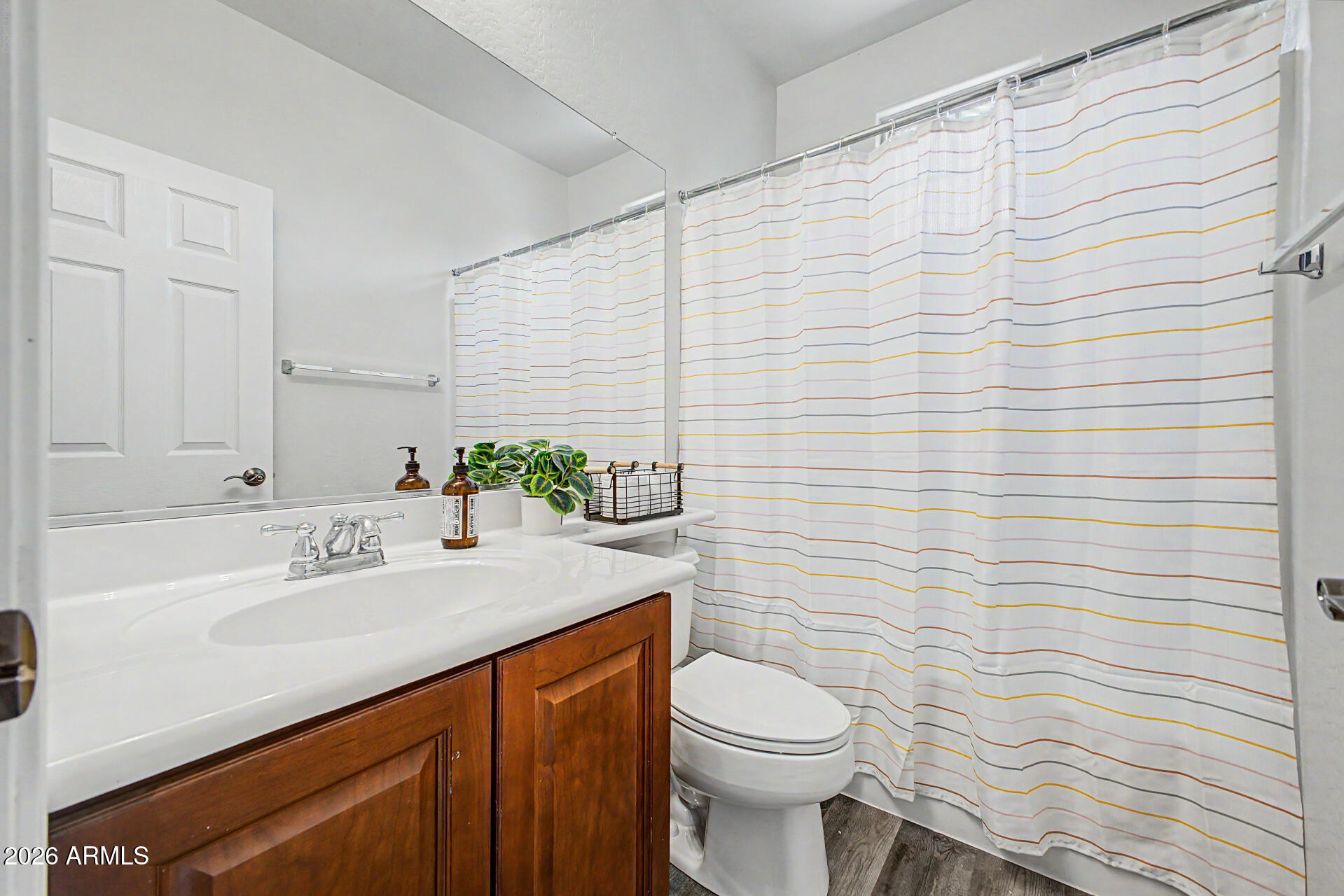 4331 East Cullumber Street Gilbert, AZ 85234 - Photo 23 of 42 a bathroom with a sink a toilet and shower curtain