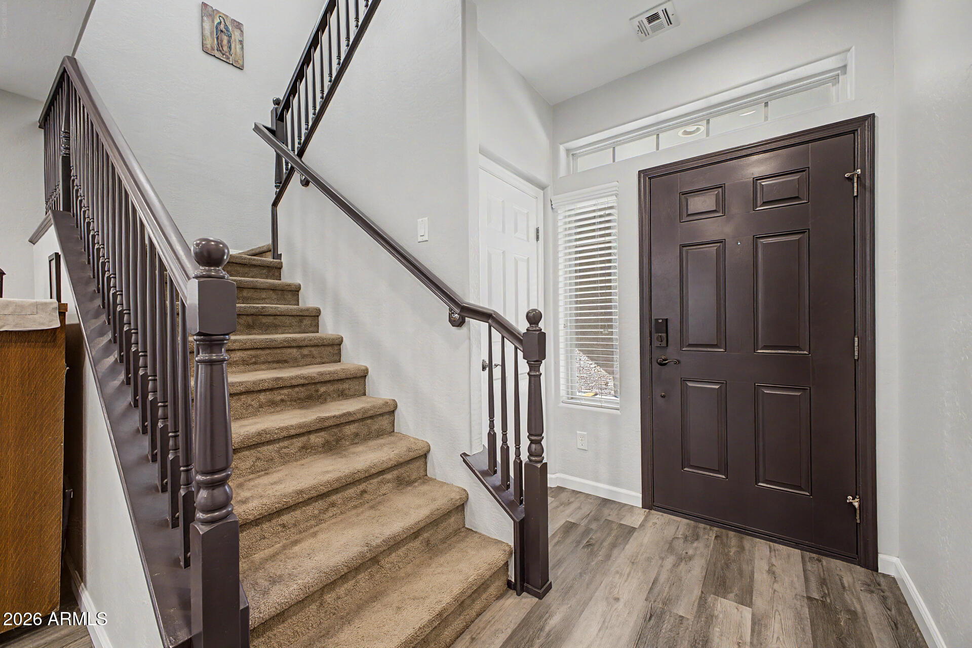 4331 East Cullumber Street Gilbert, AZ 85234 - Photo 3 of 42 a view of a hallway with wooden floor and entryway