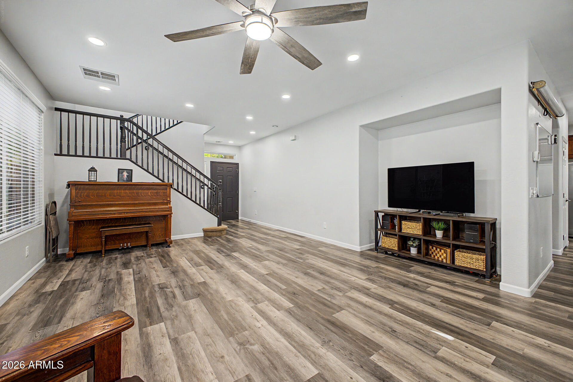 4331 East Cullumber Street Gilbert, AZ 85234 - Photo 6 of 42 a living room with furniture a flat screen tv and a wooden floor