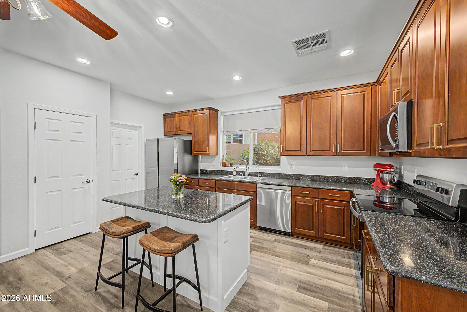 4331 East Cullumber Street Gilbert, AZ 85234 - Photo 10 of 42 a kitchen with stainless steel appliances granite countertop a sink stove and refrigerator
