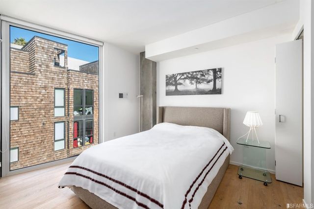 a large white bed in a white room