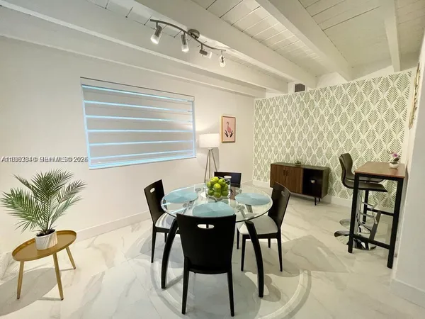 a view of a dining room with furniture and a potted plant