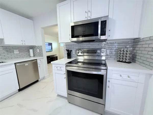 a kitchen with a stove and a microwave