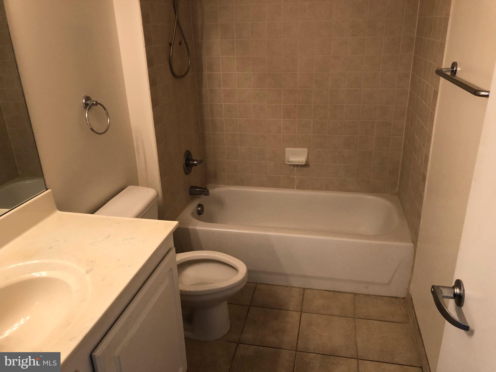 355 I Street Southwest, Unit 626 Washington, DC 20024 - Photo 2 of 8 a bathroom with a sink a toilet and shower