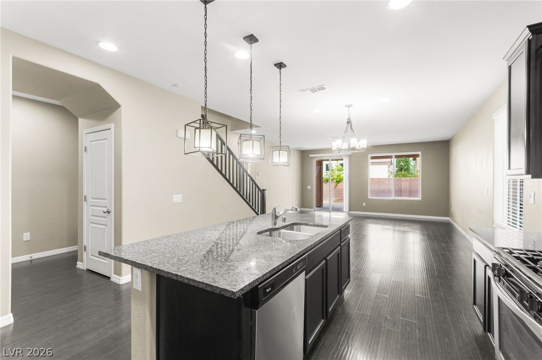 11048 Prairie Grove Road Las Vegas, NV 89179 - Photo 75 of 75 An open floorplan seamlessly connects the well-appointed kitchen to the naturally illuminated living area.