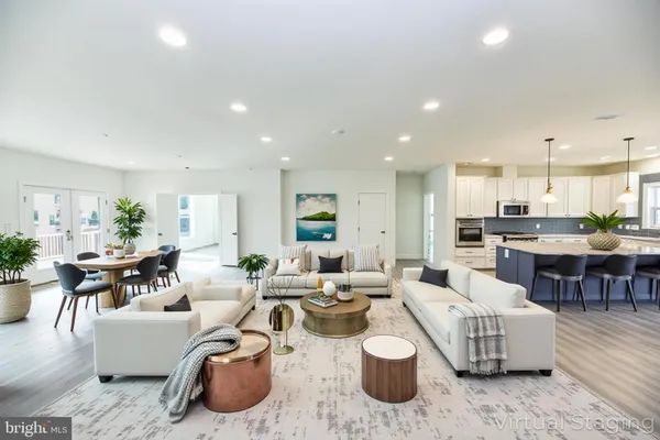 a living room with lots of furniture and kitchen view