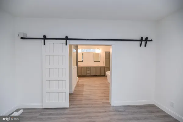 a view of a room with wooden floor