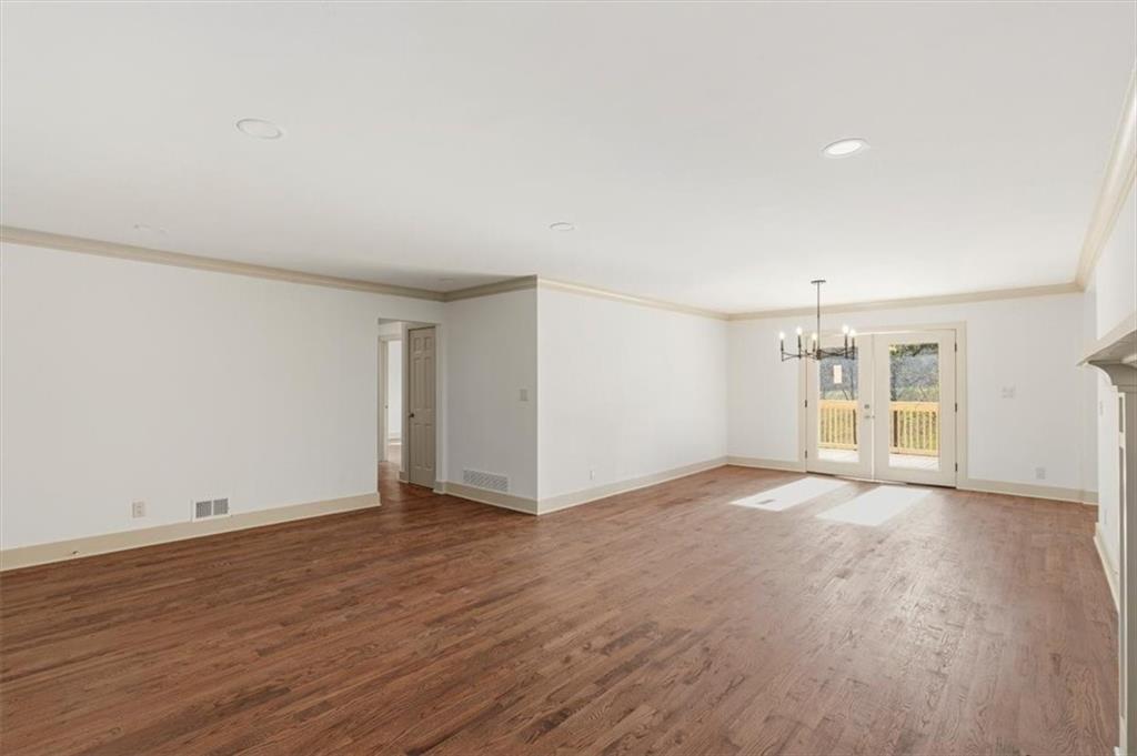 49 Apache Trail Cartersville, GA 30120 - Photo 14 of 52 an empty room with wooden floor and windows