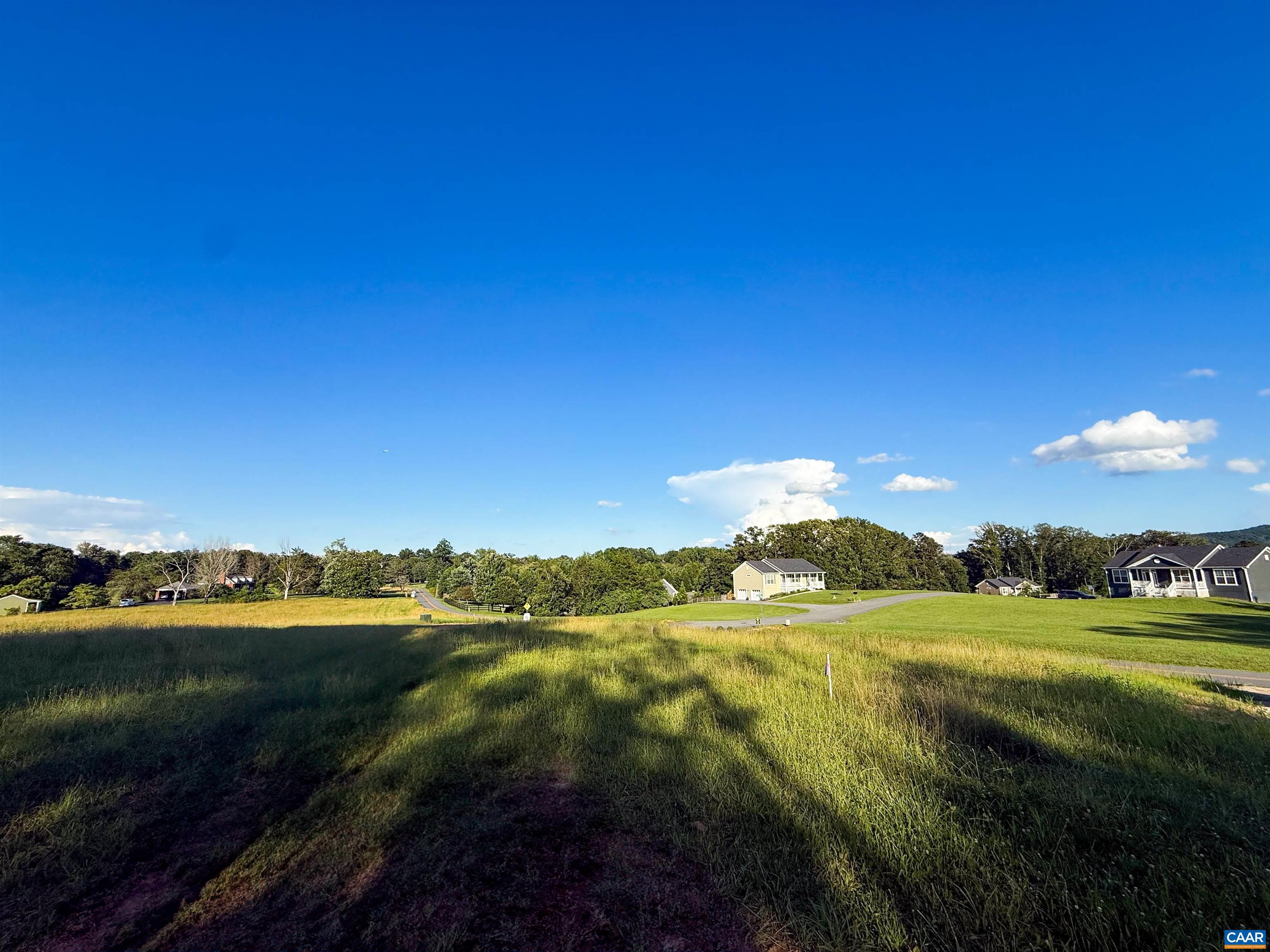 Lot 7 Advance Mills Road Ruckersville, VA 22968 - Photo 25 of 26 a view of a lake with houses in the background
