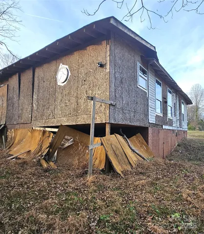 a view of a brick house next to a yard