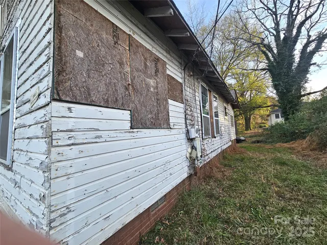 a view of wooden house with a yard