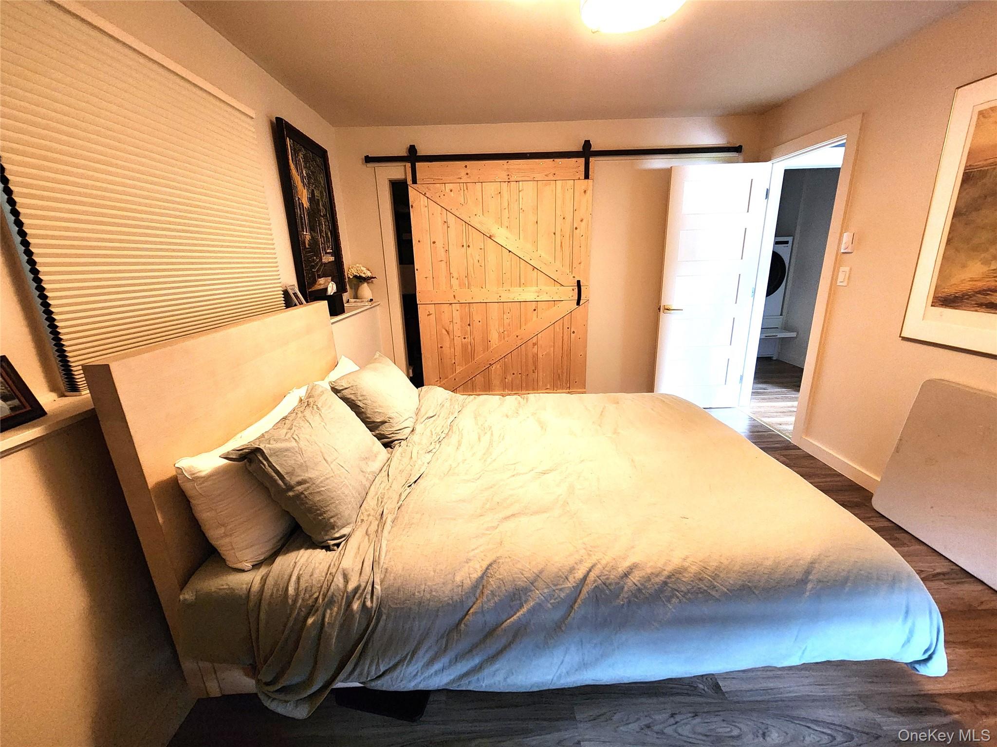 53 Lake Pleasant Road Staatsburg, NY 12580 - Photo 22 of 34 a bedroom with a bed and wooden floor