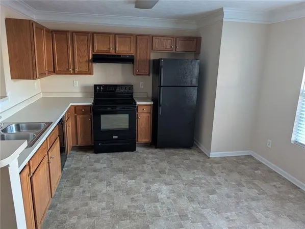 a kitchen with a refrigerator and a sink
