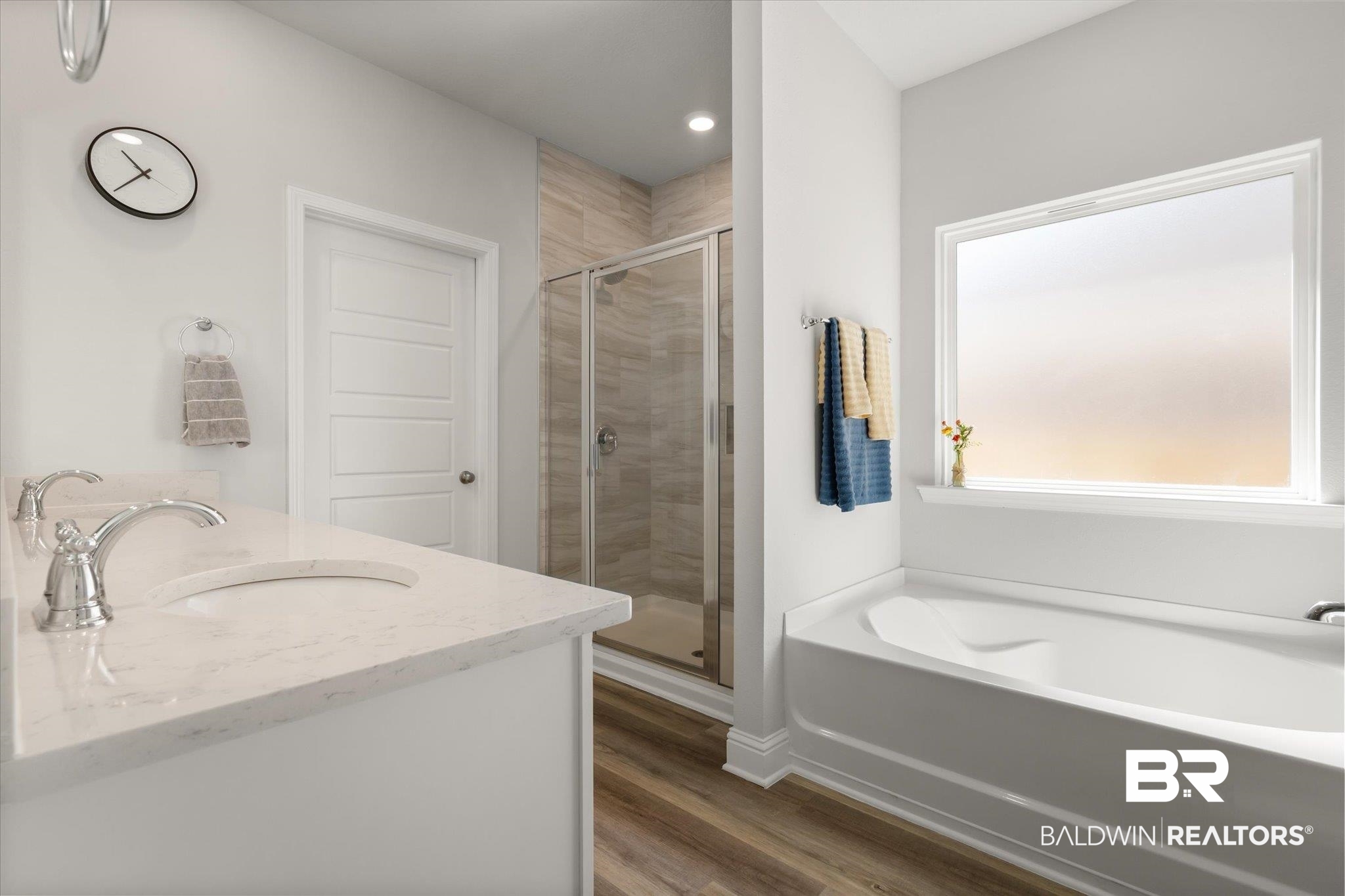 1167 Provision Road Mobile, AL 36608 - Photo 11 of 20 Bathroom featuring a shower stall, a garden tub, double vanity, wood finished floors, and a sink