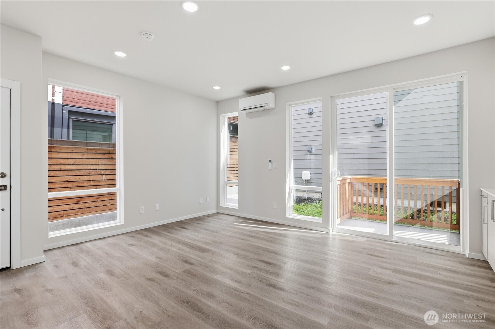 1816 24th Avenue South Seattle, WA 98144 - Photo 4 of 20 an empty room with wooden floor and windows