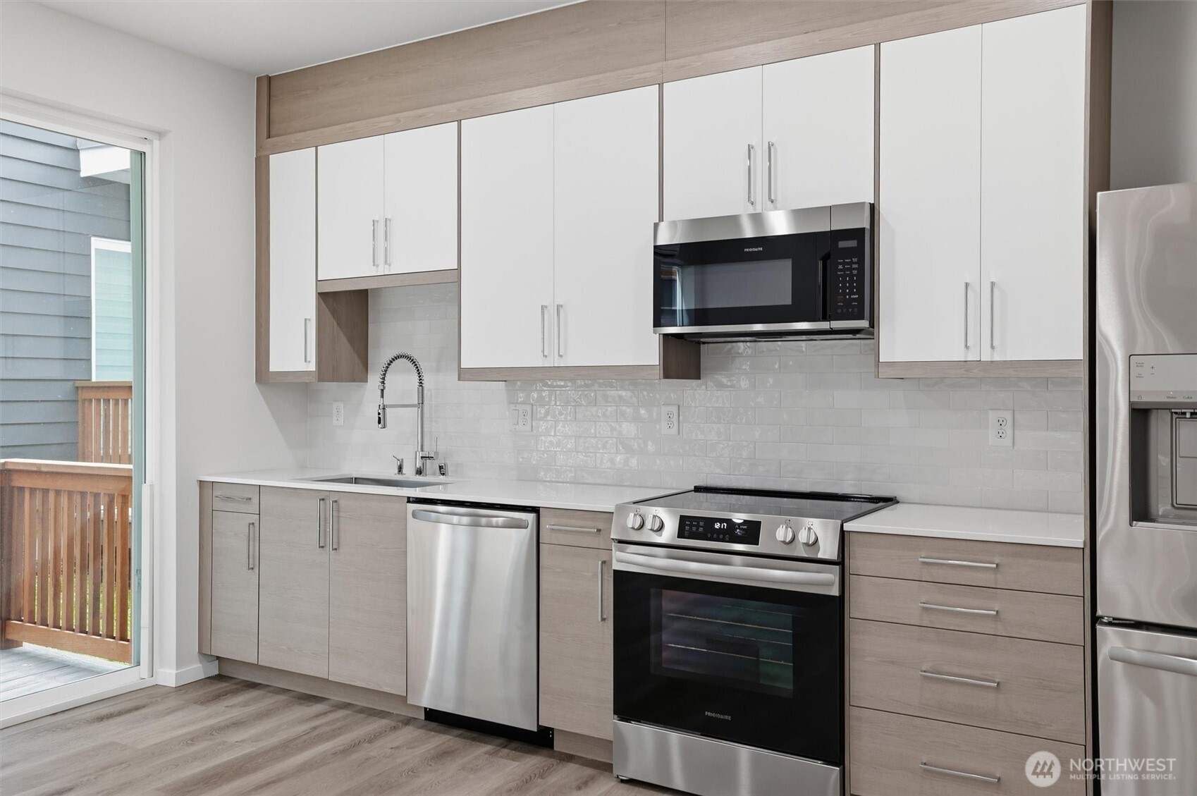 1816 24th Avenue South Seattle, WA 98144 - Photo 8 of 20 a kitchen with stainless steel appliances granite countertop white cabinets a sink and a stove