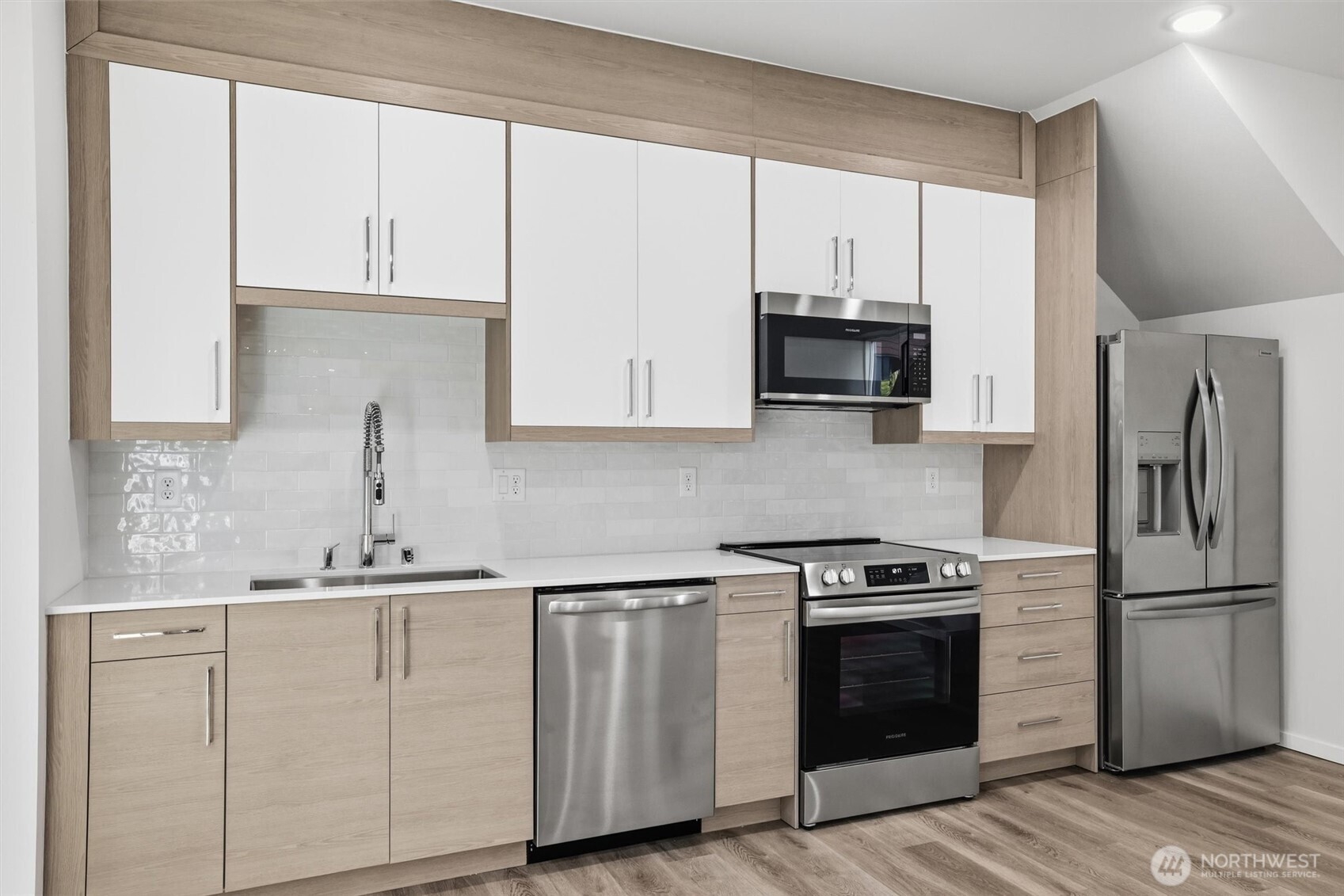 1816 24th Avenue South Seattle, WA 98144 - Photo 9 of 20 a kitchen with white cabinets and stainless steel appliances