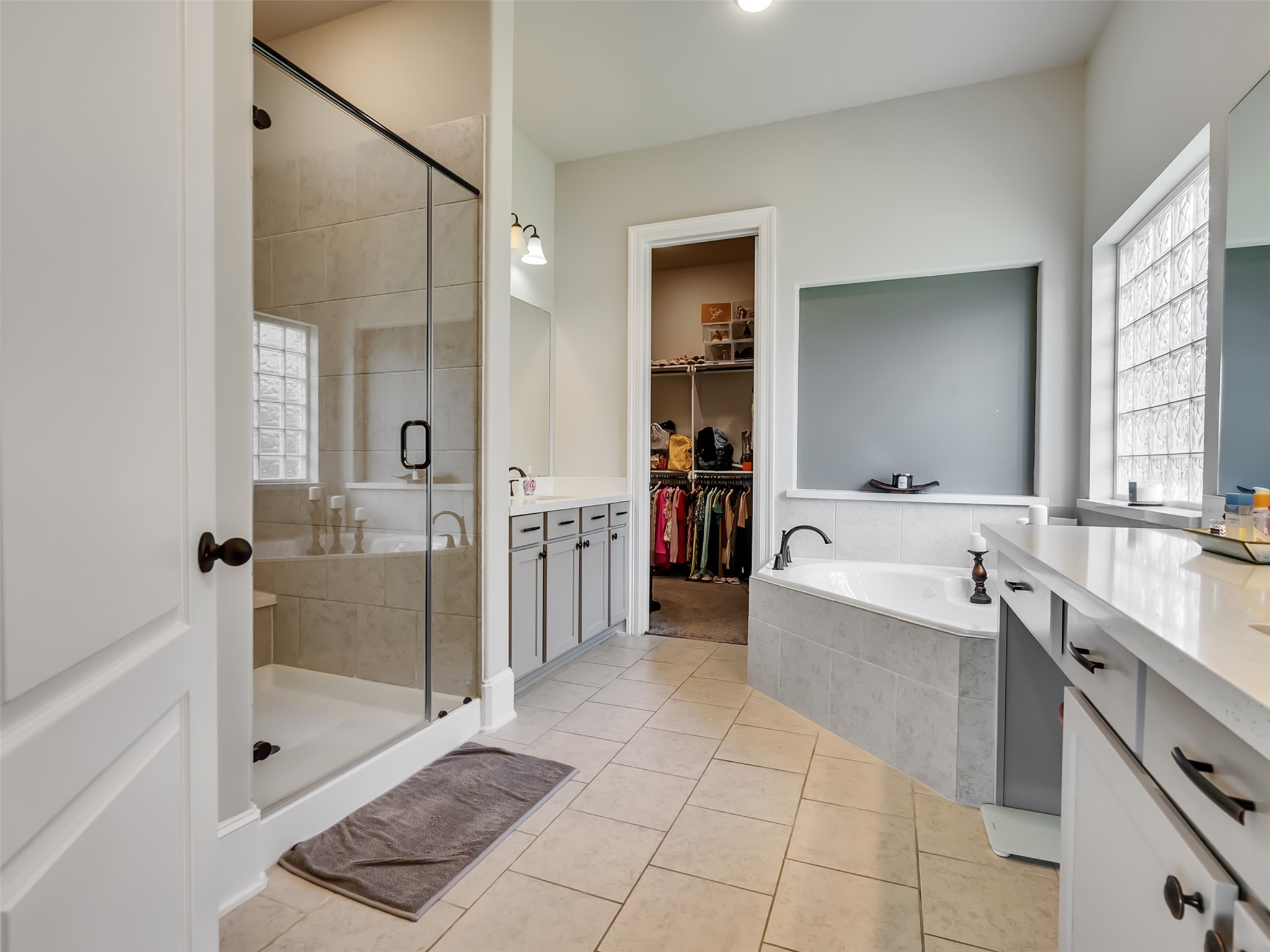 10302 Muir Peak Drive Rosharon, TX 77583 - Photo 21 of 40 Glass enclosed shower, jacuzzi tub, and dual vanities make this Primary bathroom special.
