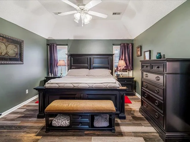 a bedroom with a bed and a chandelier