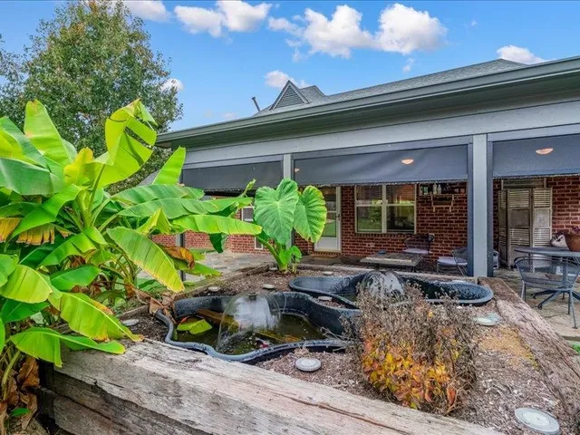 a view of a house with swimming pool yard and outdoor seating