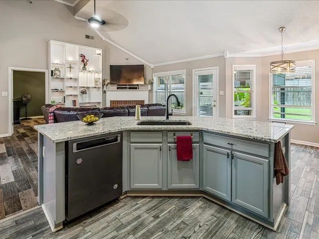 a kitchen with a sink stove and microwave