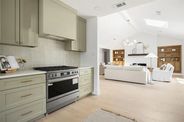 a kitchen with stainless steel appliances granite countertop a stove and a sink