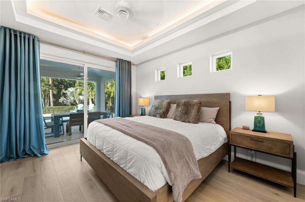 1963 Bethany Place Naples, FL 34109 - Photo 11 of 47 a bedroom with a bed and wooden floor