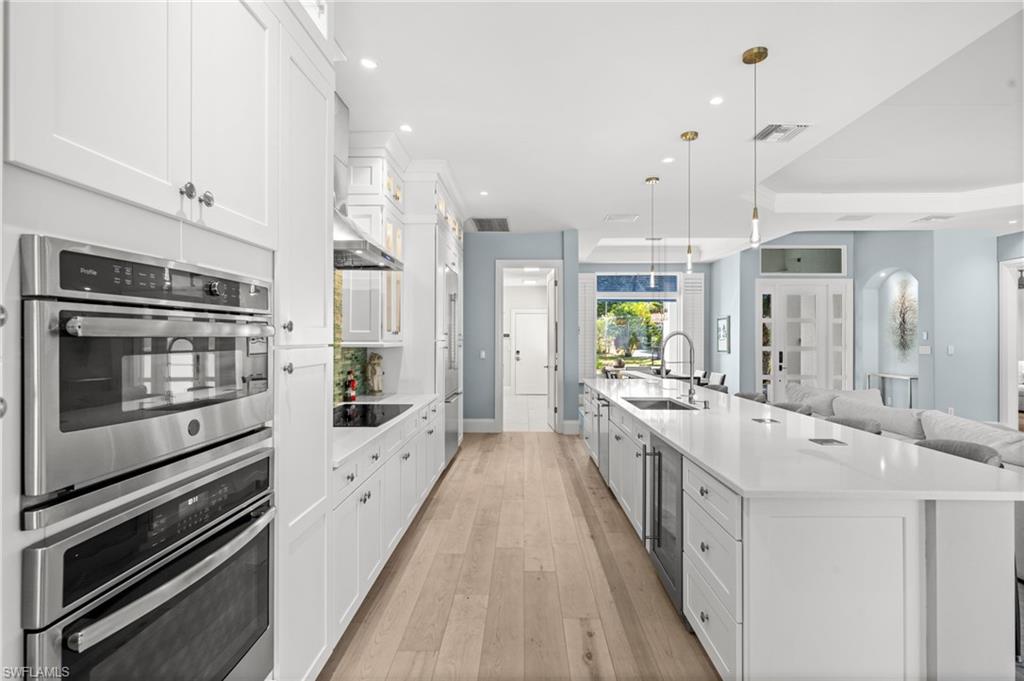 1963 Bethany Place Naples, FL 34109 - Photo 12 of 50 A stunning kitchen with double ovens, induction cooktop, and an expansive island perfect for prepping, serving, and gathering.