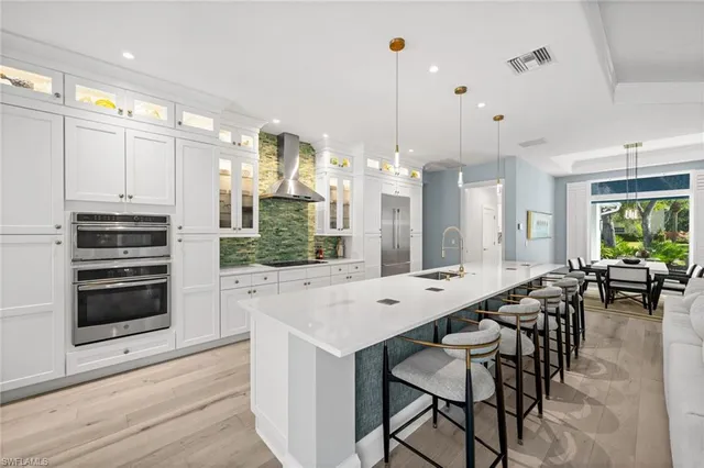 a large kitchen with a table and chairs