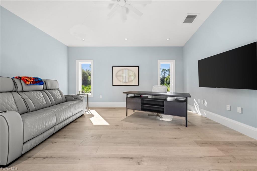 1963 Bethany Place Naples, FL 34109 - Photo 22 of 47 a living room with furniture and a flat screen tv