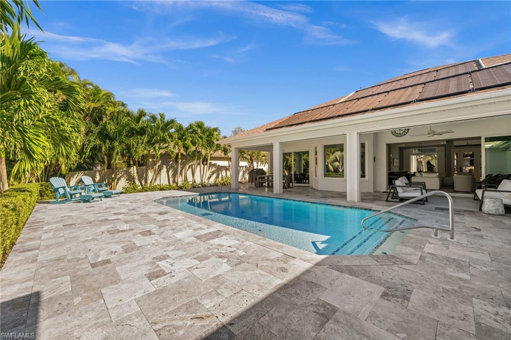 1963 Bethany Place Naples, FL 34109 - Photo 27 of 47 a view of house with swimming pool and sitting area