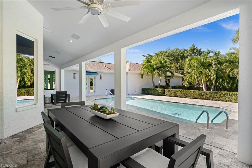 1963 Bethany Place Naples, FL 34109 - Photo 29 of 50 A spacious covered lanai offers seamless transition from the heart of the home to the pool.
