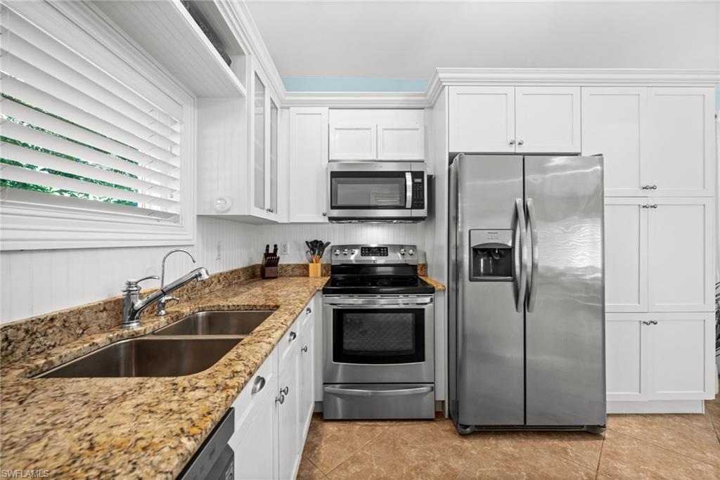 1963 Bethany Place Naples, FL 34109 - Photo 38 of 47 a kitchen with a sink stove and refrigerator