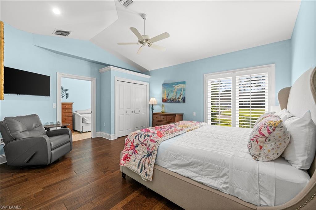 1963 Bethany Place Naples, FL 34109 - Photo 40 of 47 a bedroom with a bed and wooden floor